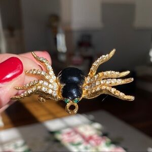 Spider Pin Brooch w/crystal legs and green stone eyes. Set in gold-tone metal